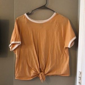 yellow crew t shirt that’s tied up, white cuffs